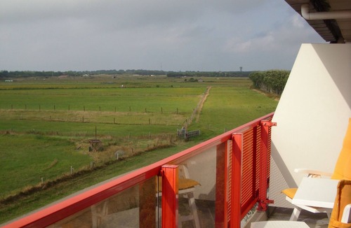 Municipality of Ameland Apartment | Ameland - apartment with balcony to the south side with a view of meadows and the village of Buren